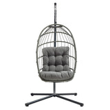 Silla colgante tipo huevo de ratán gris con cojín acolchado, estructura metálica negra y diseño moderno y elegante