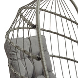 Silla colgante tipo huevo de ratán gris con cojín suave, diseño moderno y estructura entrelazada que aporta comodidad y estilo