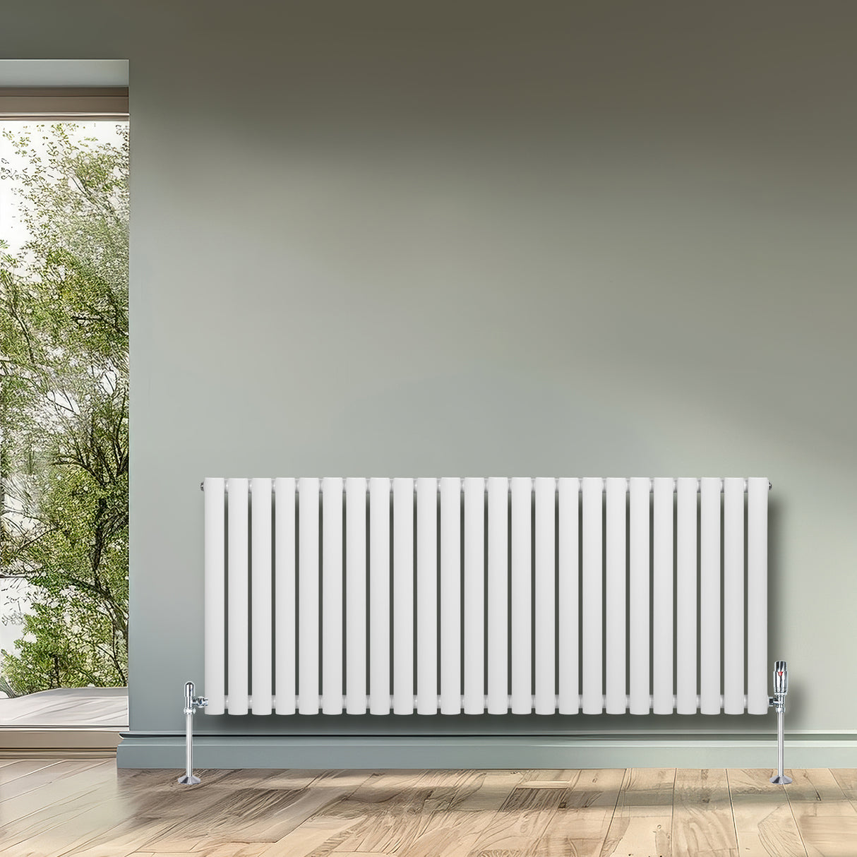 Radiador de columna ovalado blanco de 600 mm x 1440 mm, con válvulas, instalado en una pared gris junto a una ventana con vista al exterior