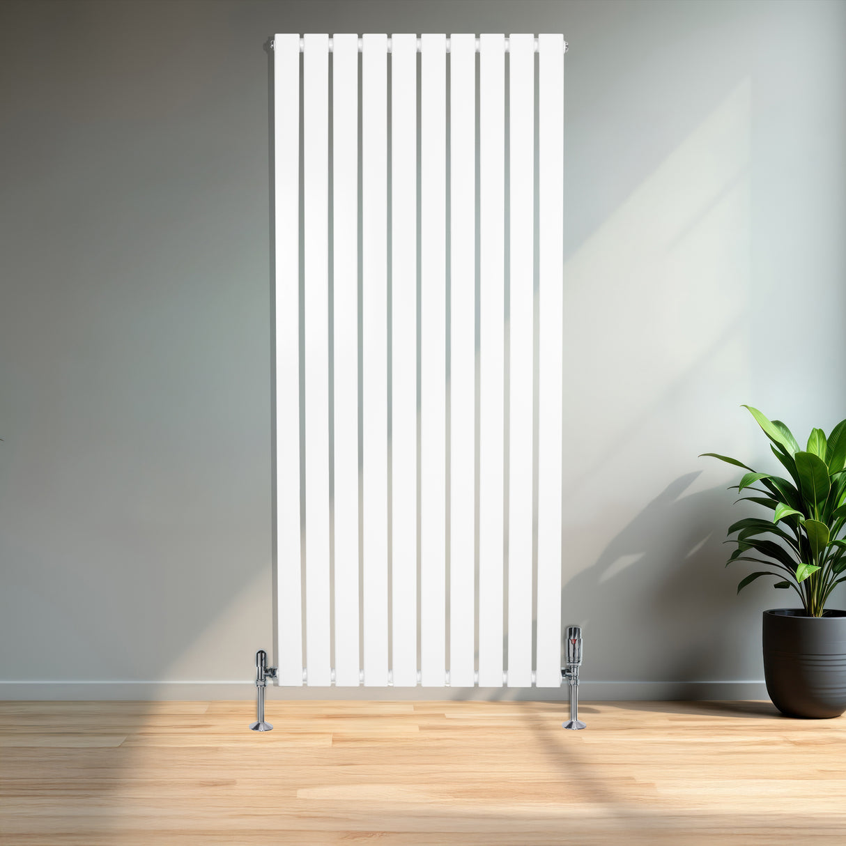 Radiador plano de columna simple en color blanco, con válvulas, de 1600 x 700 mm, instalado en un ambiente moderno y luminoso