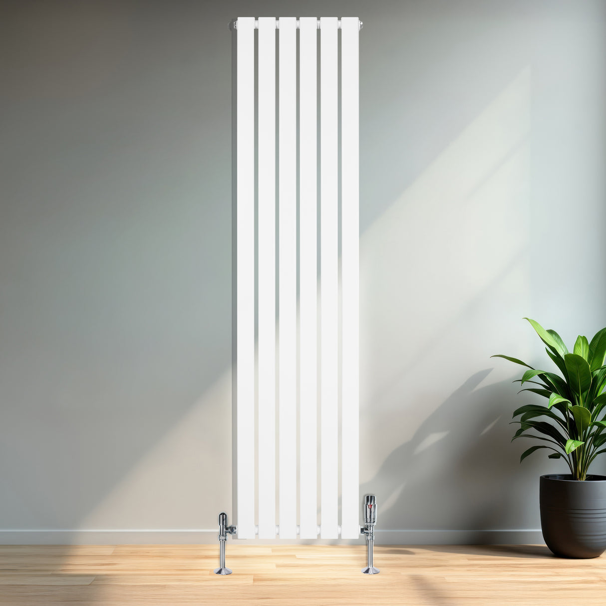 Radiador plano de columna simple blanco de 1800 mm x 420 mm, con válvulas, instalado en una pared junto a una planta decorativa
