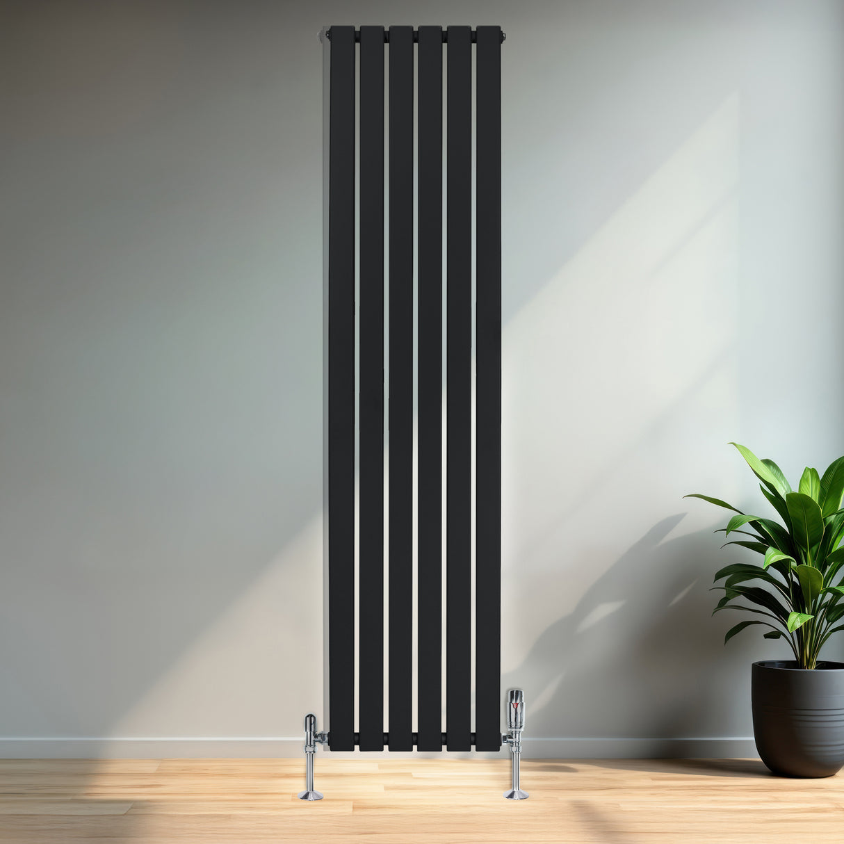 Radiador plano de columna simple negro, 1800 mm x 420 mm, con válvulas, instalado en una pared de un ambiente moderno y luminoso