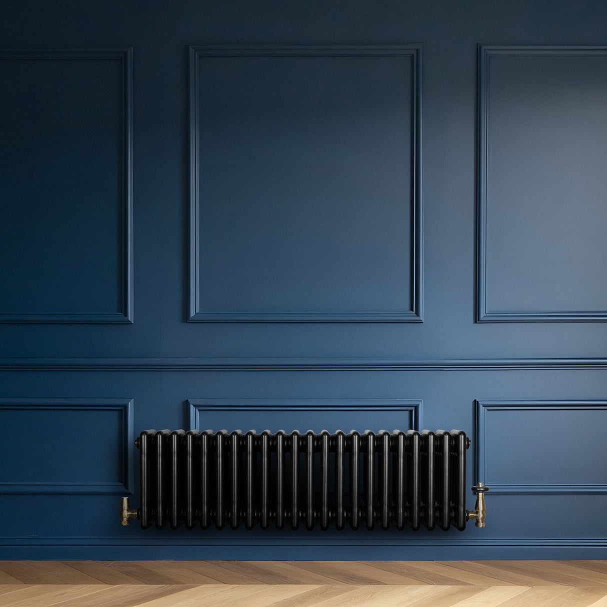 Radiador tradicional negro de 4 columnas, con válvulas, instalado en una pared azul, complementando un suelo de madera clara