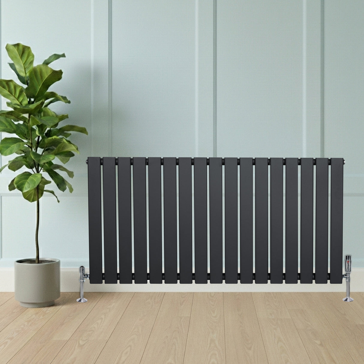 Radiador de columna única gris antracita de 600 mm x 1190 mm, con diseño moderno y acabado liso, junto a una planta en maceta