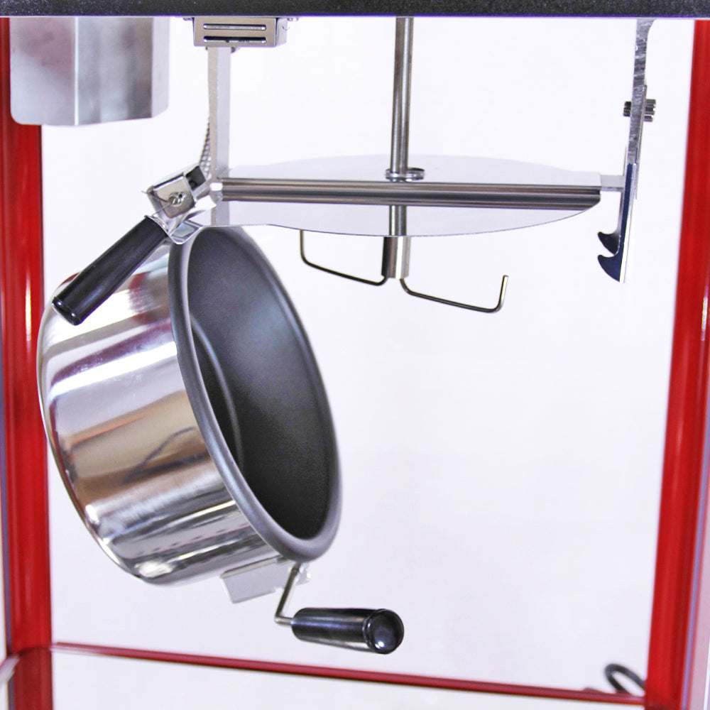 Máquina de palomitas con cacerola de acero inoxidable, mango negro y estructura roja, ideal para eventos y fiestas